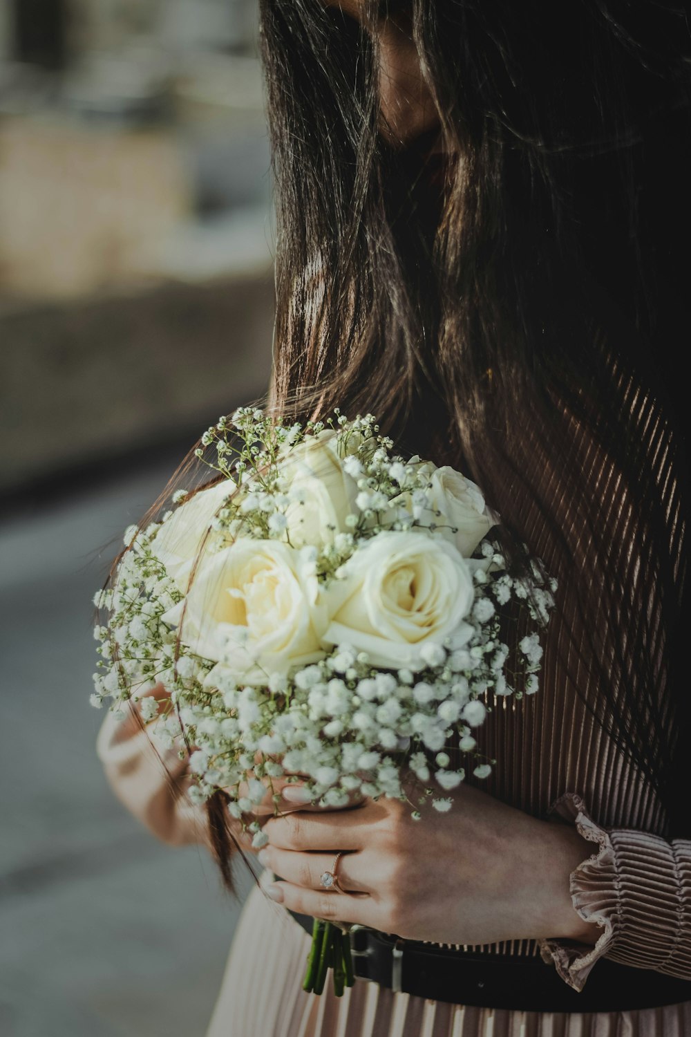 a close up of a person holding a bouquet of flowers