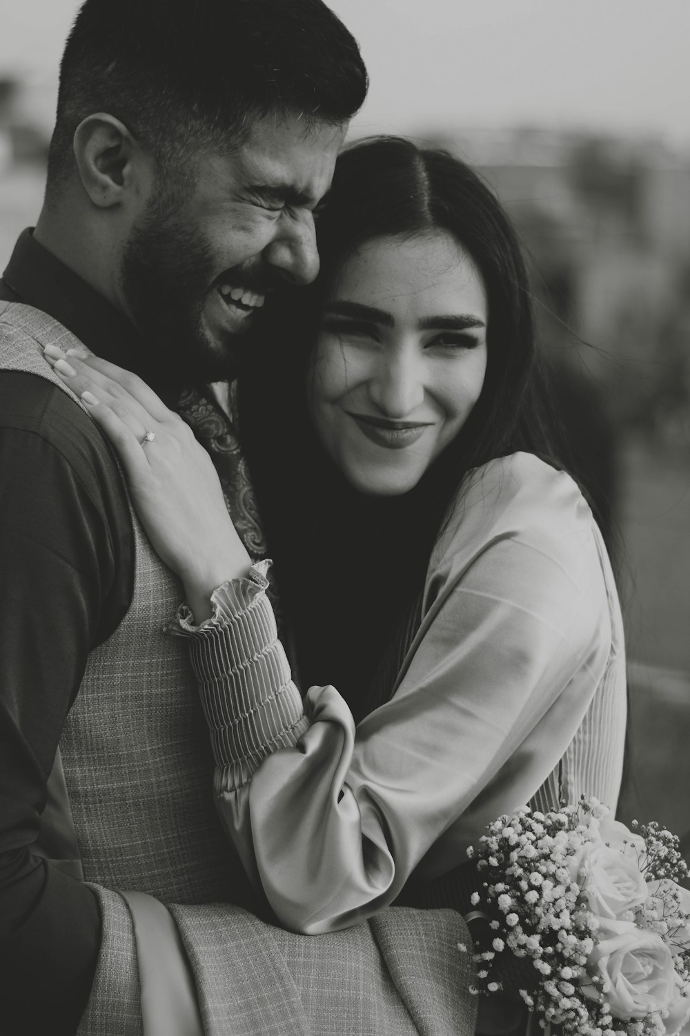 a black and white photo of a couple hugging