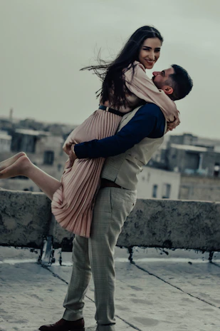 A couple training together with calisthenics moves on a city rooftop, radiating energy and connection.
