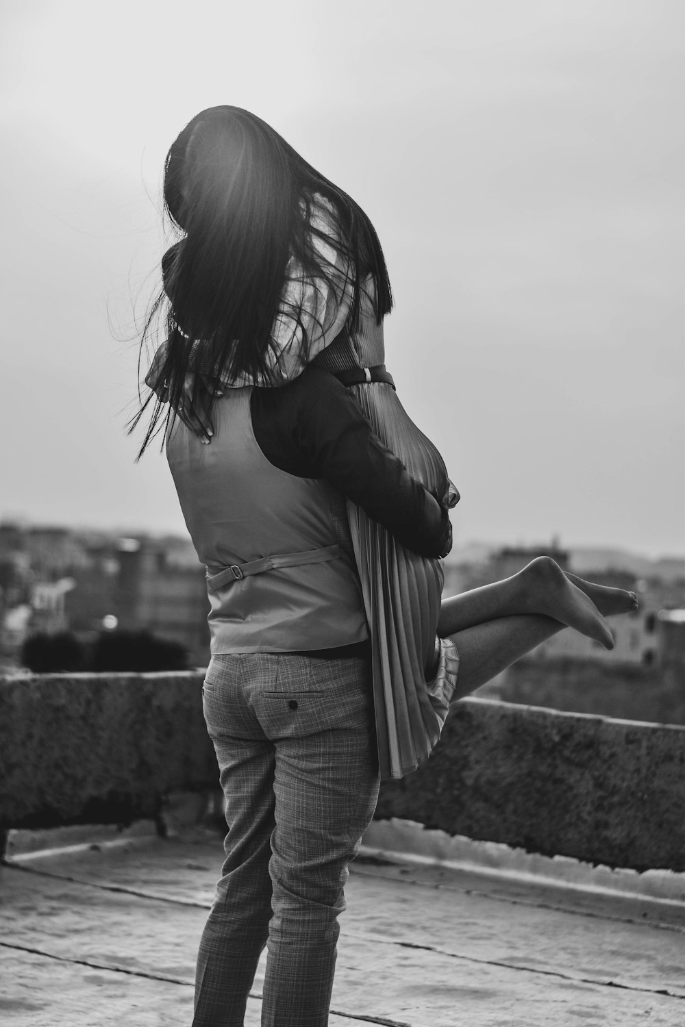 a woman standing on top of a roof