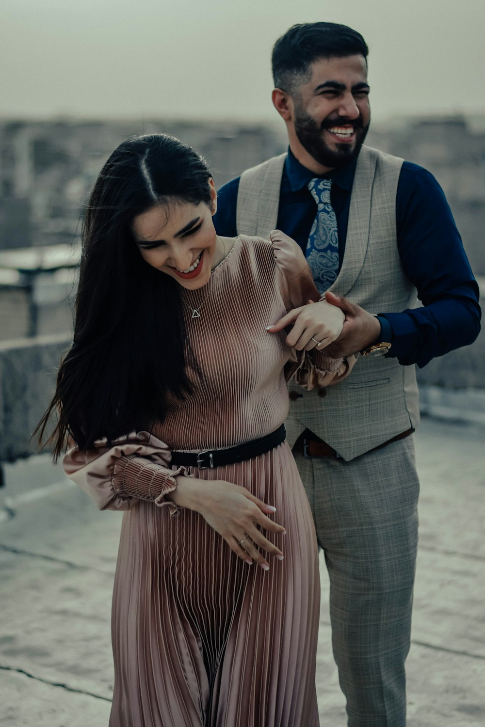 a man standing next to a woman on top of a roof