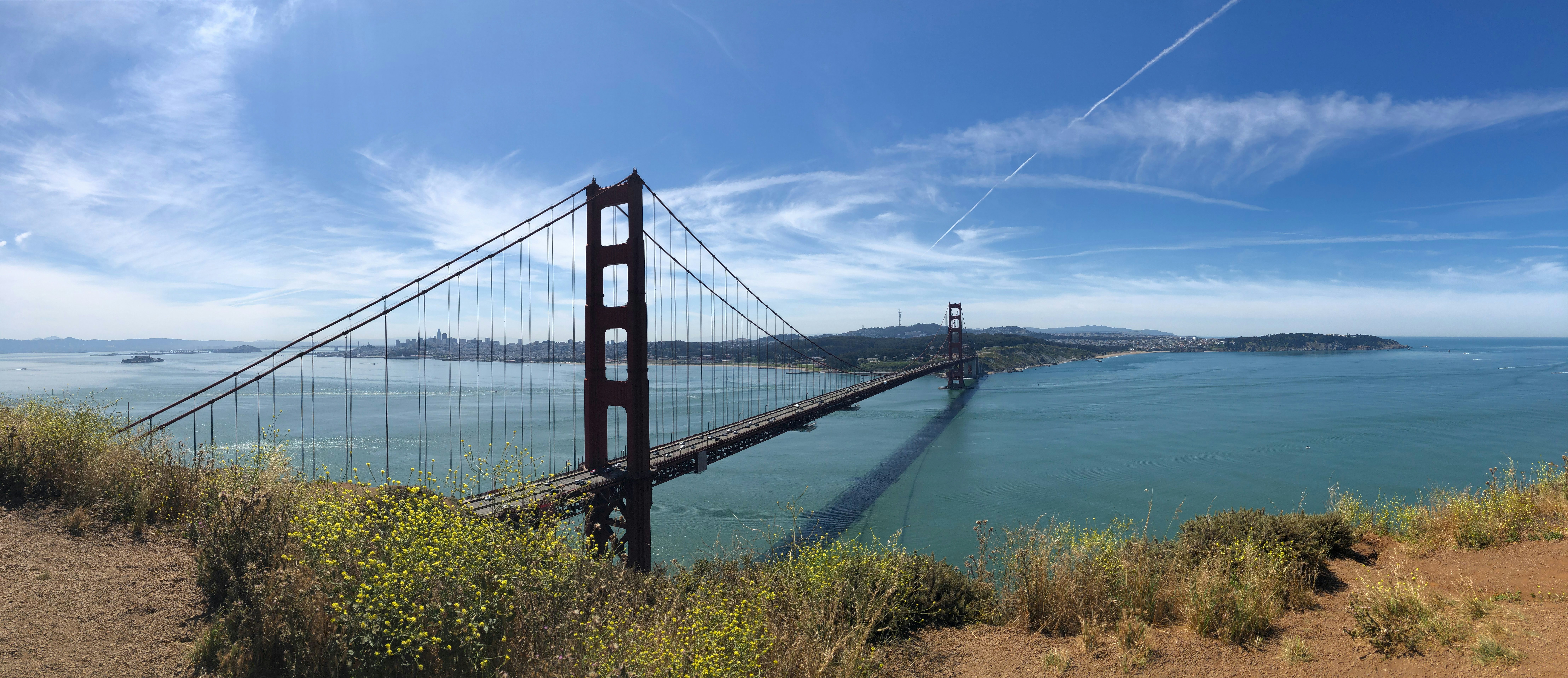 a view of the golden gate bridge from the top of a hill