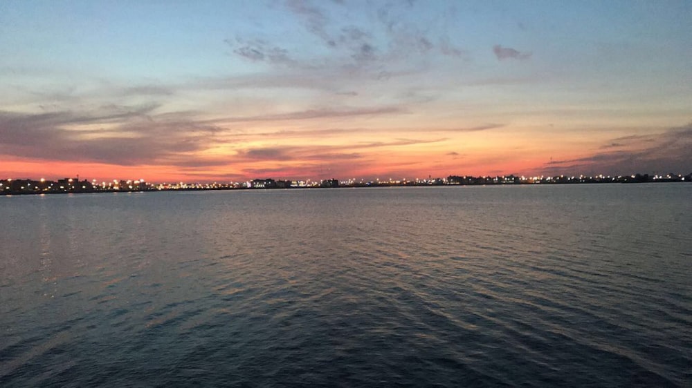 a body of water with a city in the background