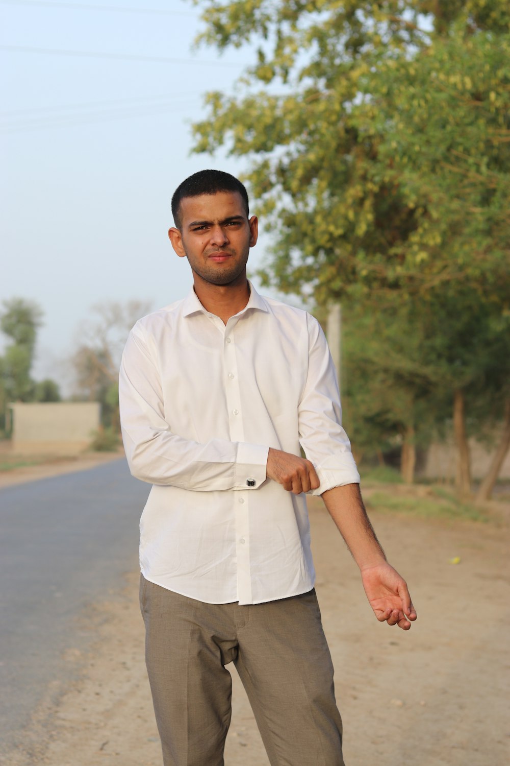 a man standing on the side of a road