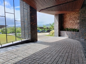 a room with a brick floor and large windows