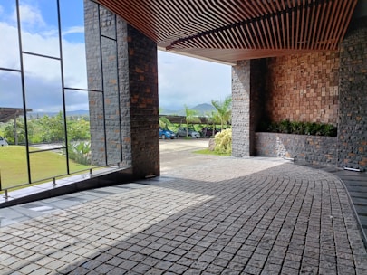 a room with a brick floor and large windows