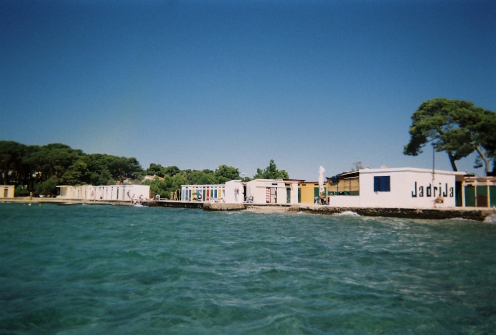 a white building sitting on top of a body of water