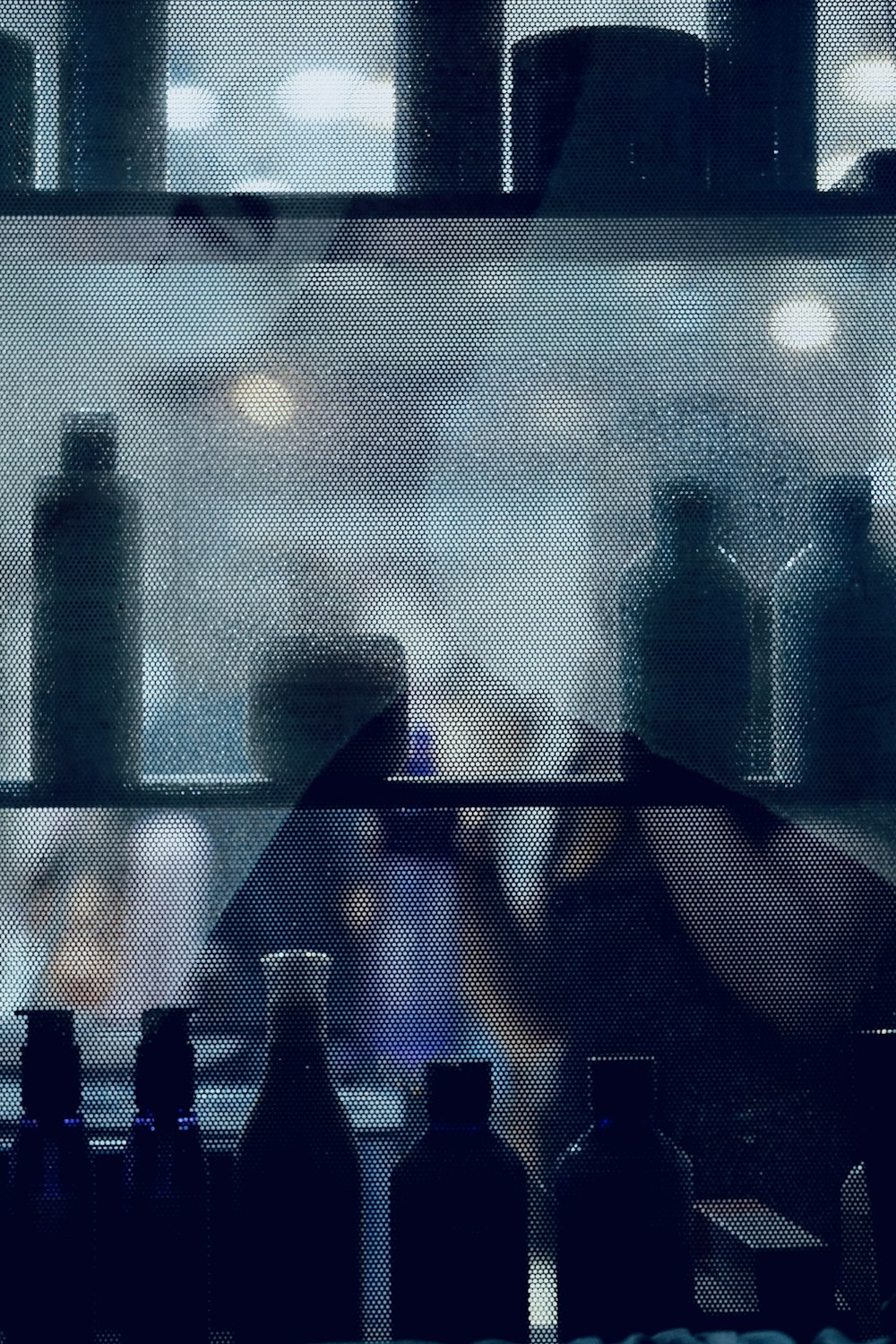 a blurry photo of bottles on a shelf