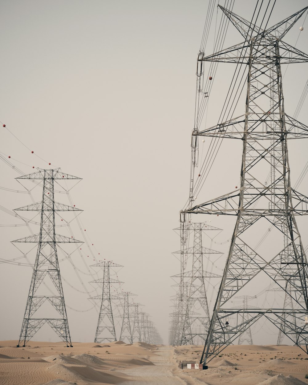 a group of power lines in the desert