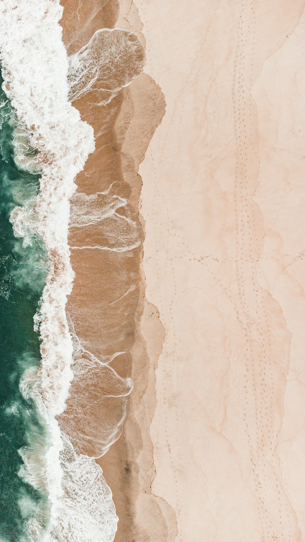 an aerial view of a sandy beach and ocean