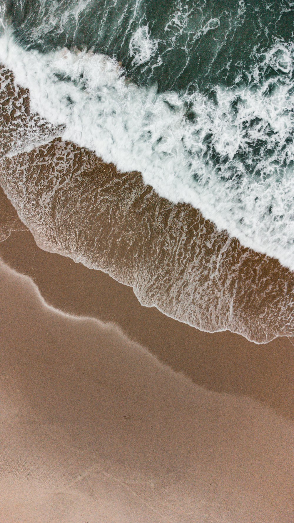 a bird's eye view of a beach and ocean