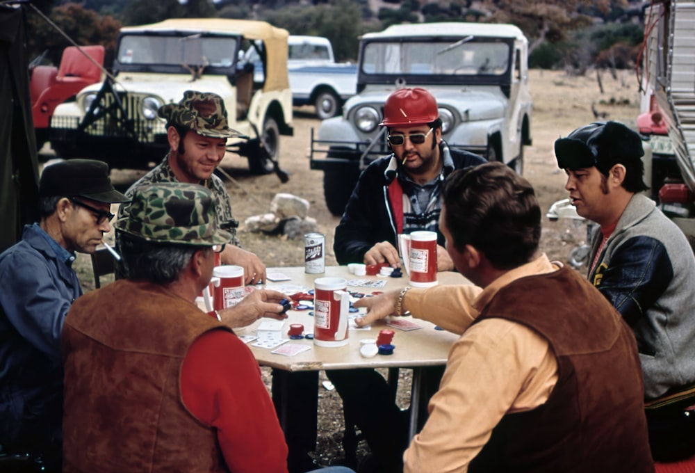 a group of men sitting around a table