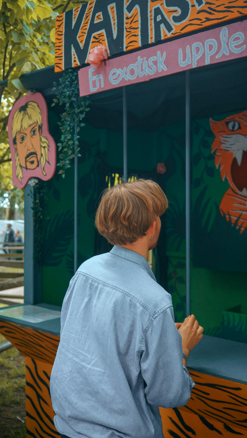 a young boy standing in front of a kiosk