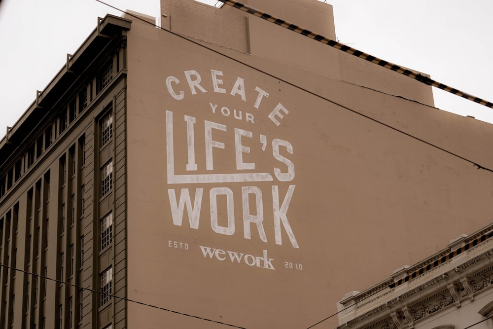 a sign on the side of a building that says create your life's work