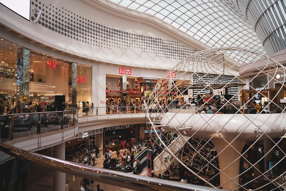 a group of people walking around a shopping mall