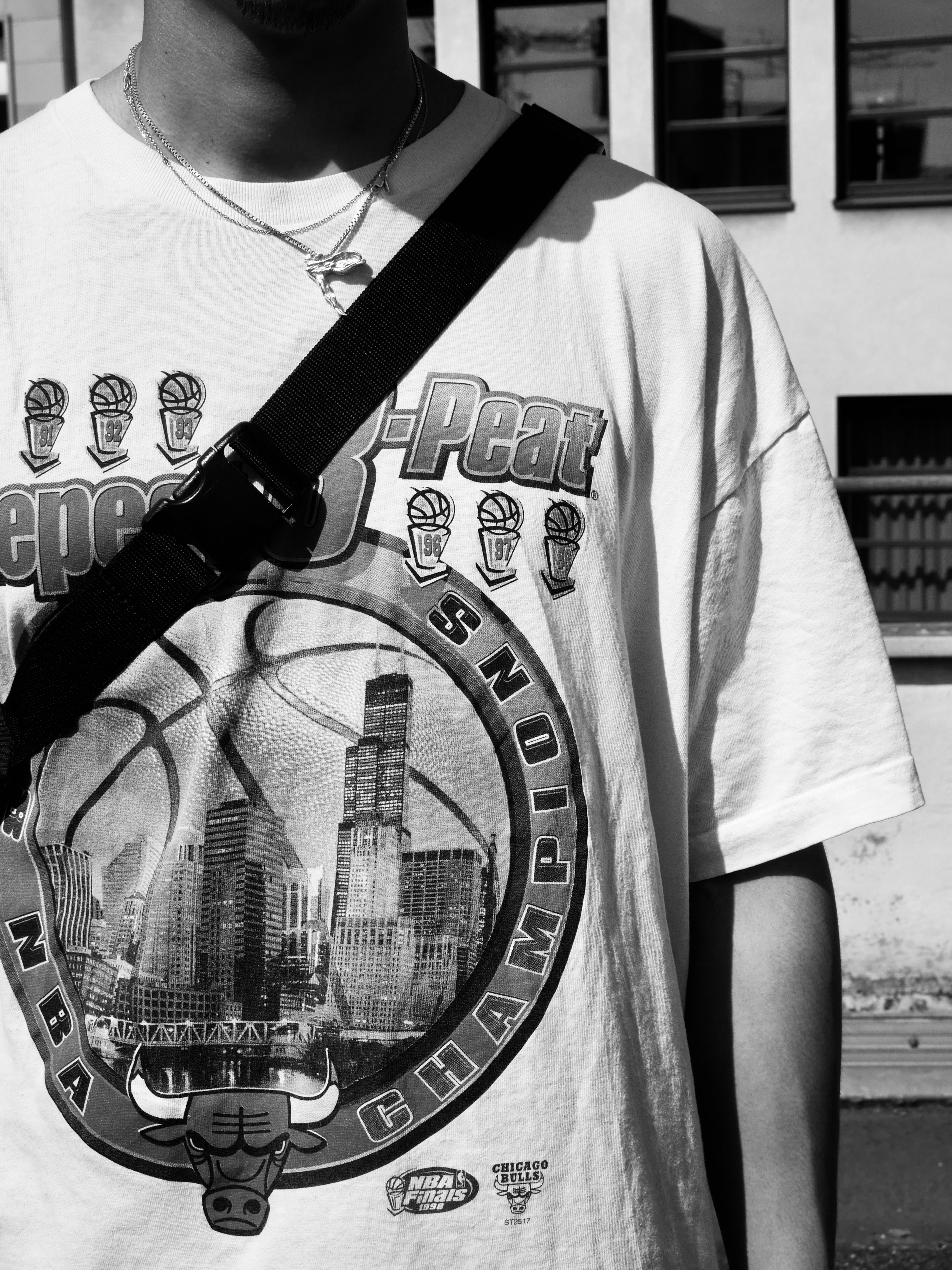 a man holding a camera strap around his neck