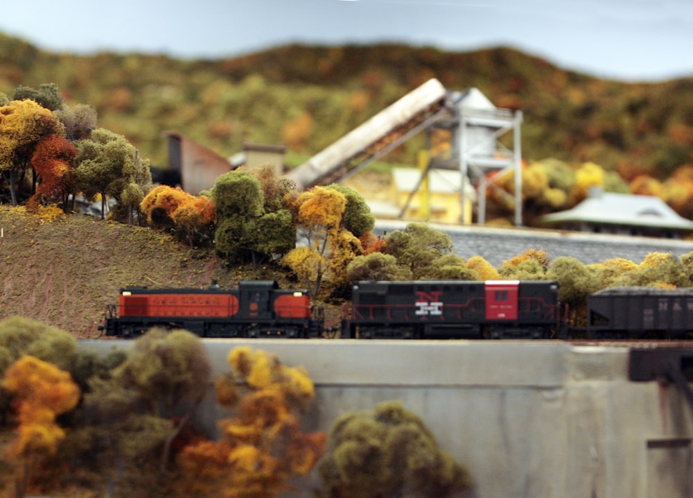 a model of a train traveling through a forest