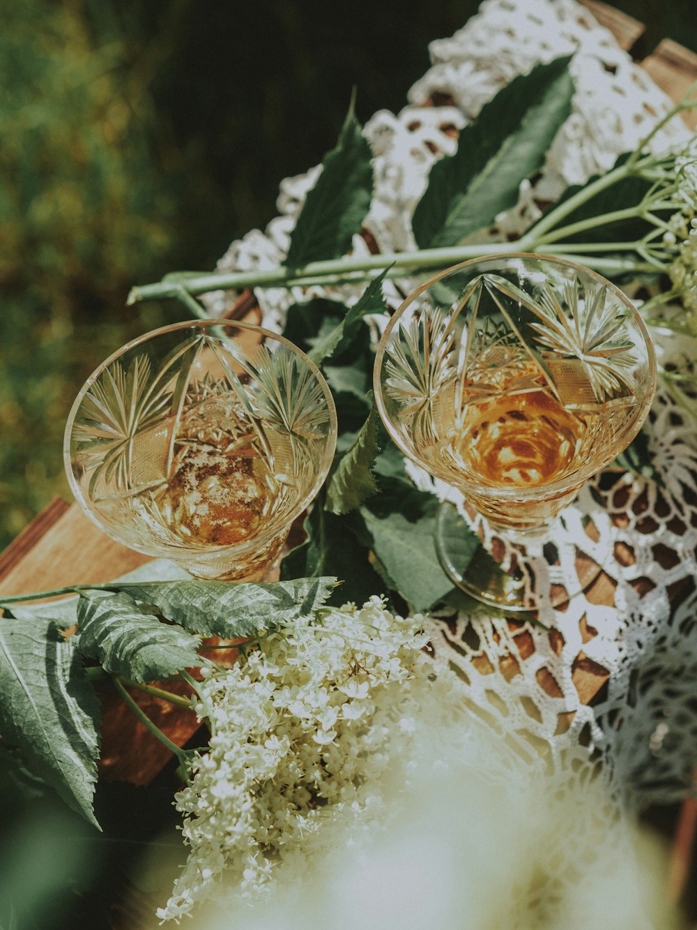 two wine glasses sitting on top of a wooden table