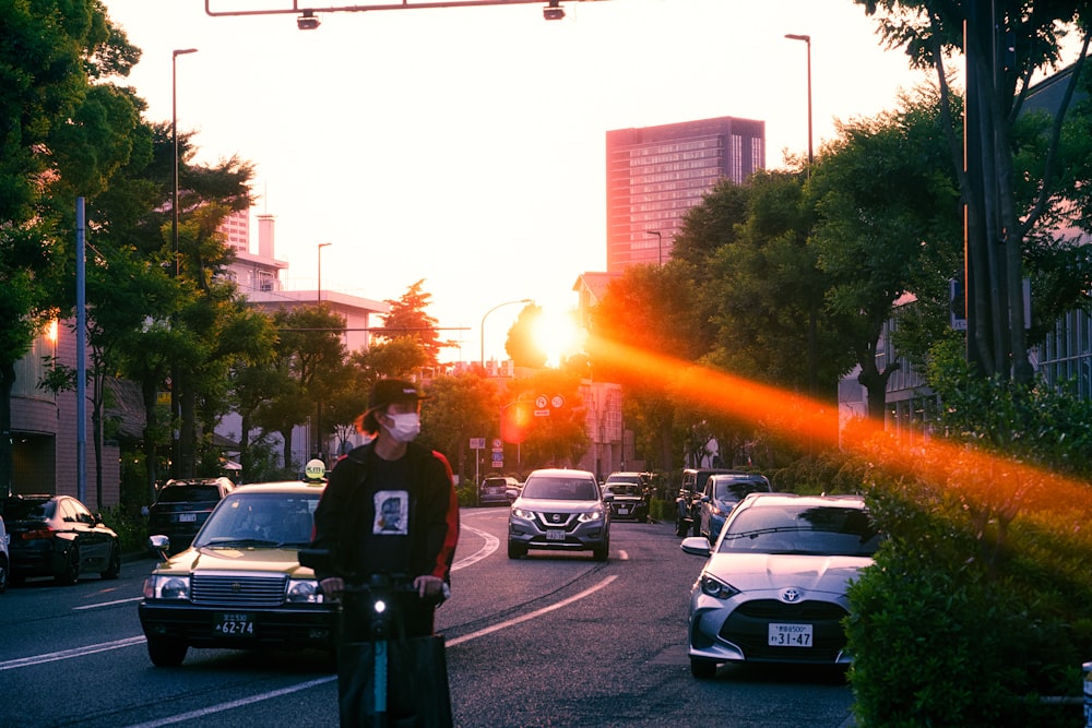 a man standing on the side of a road next to a traffic light