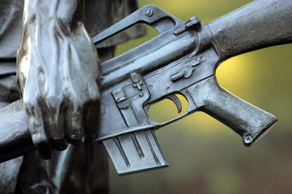 a close up of a gun on a statue