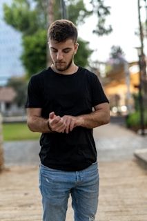 A young professional glancing at their Urbantick watch while walking through a busy city street.
