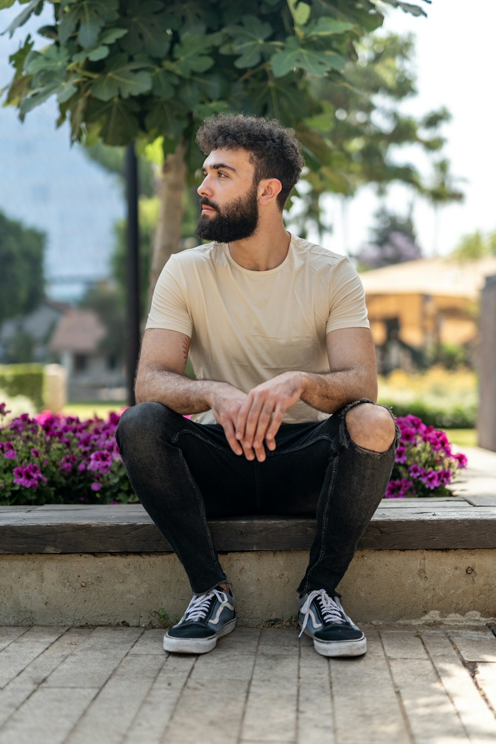 a man with a beard sitting on a bench