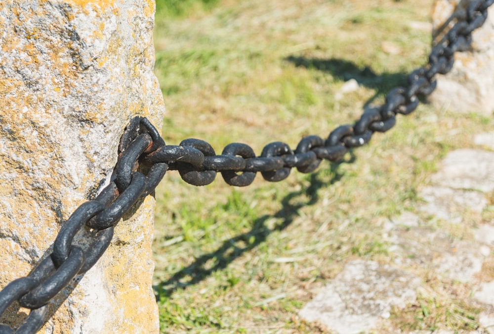a black chain is attached to a rock