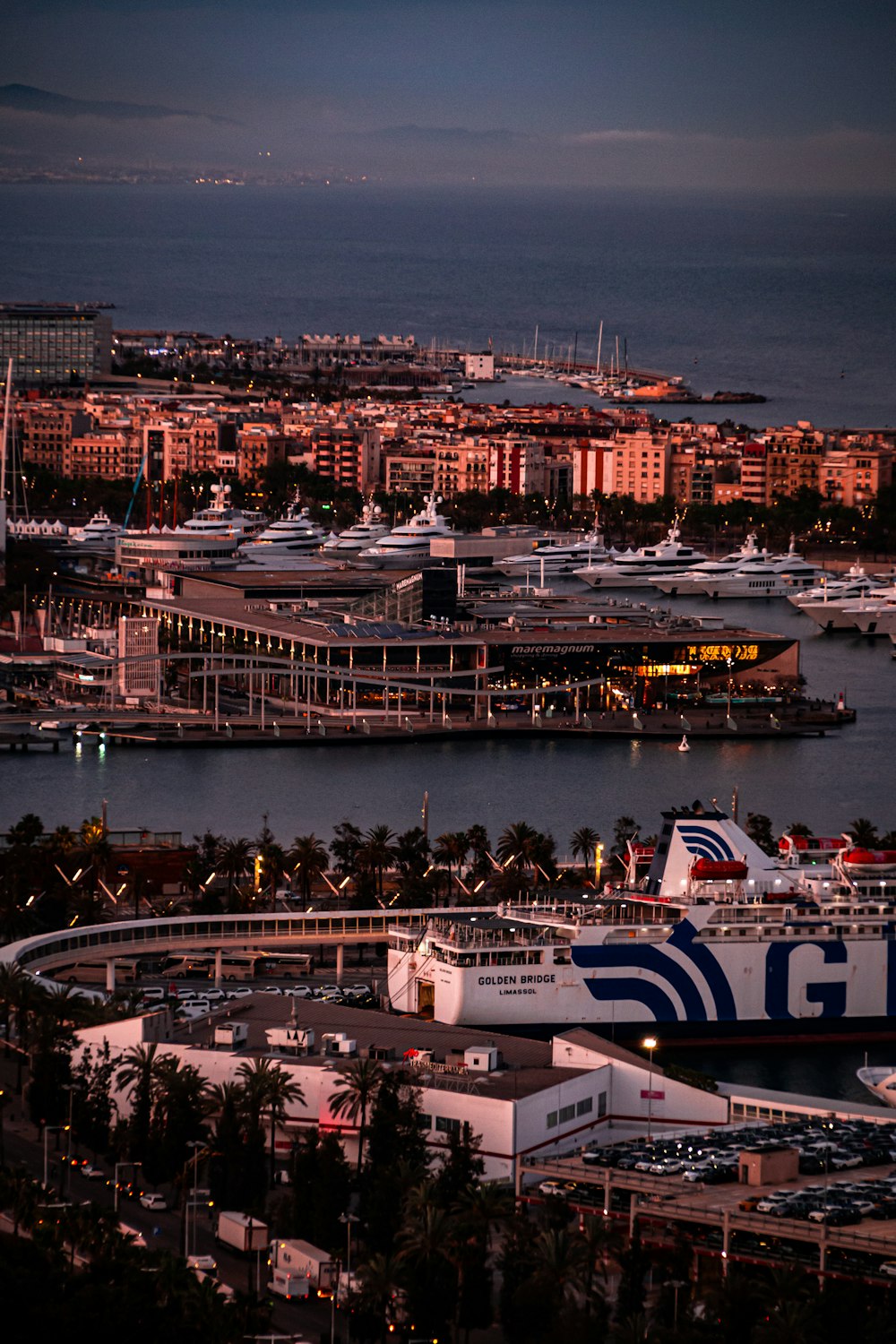 a harbor filled with lots of boats next to a city