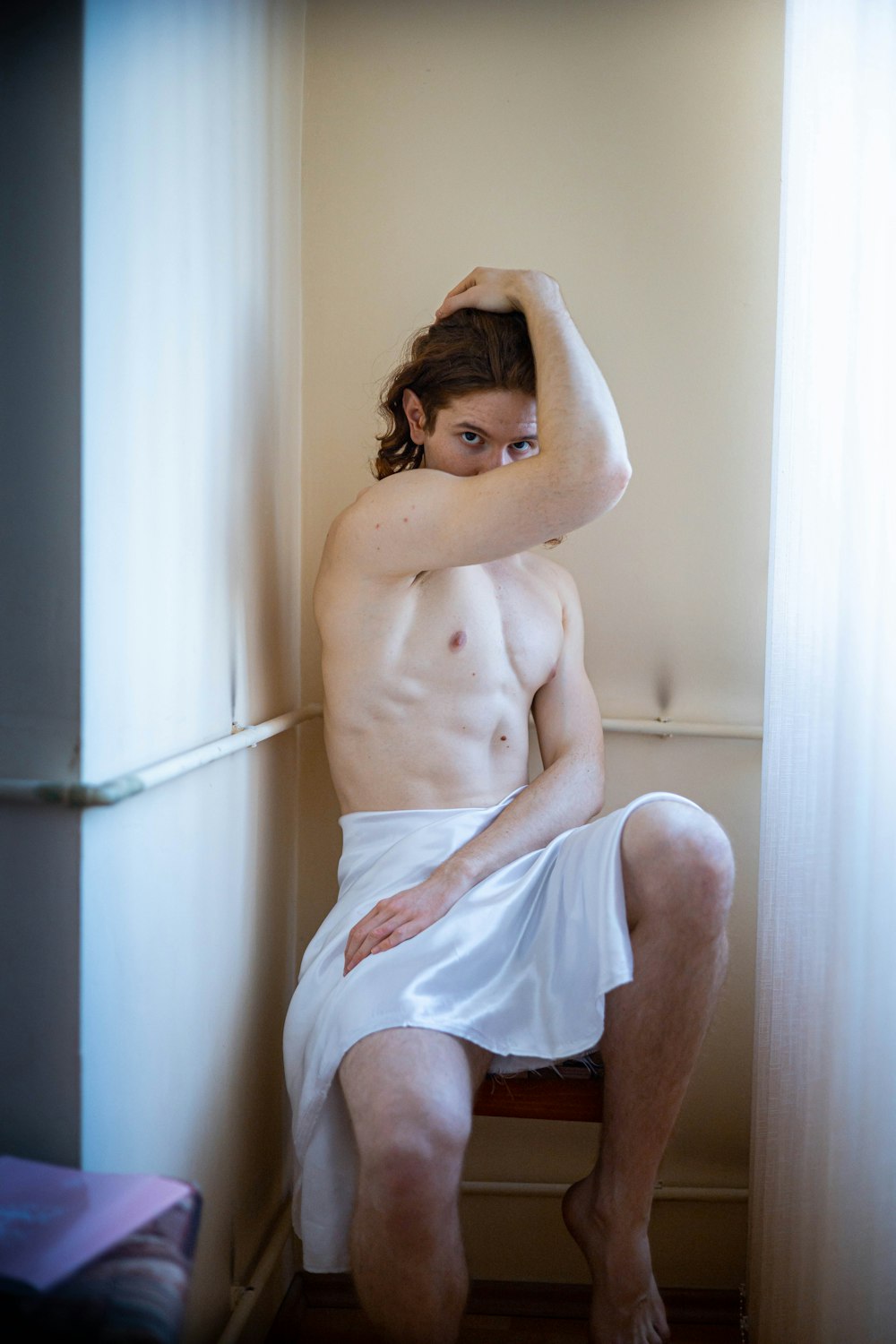 a man in a towel sitting on a chair