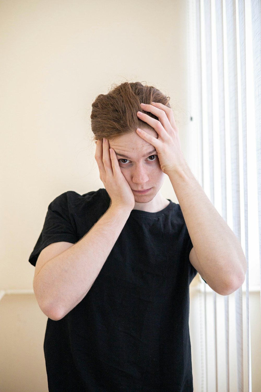 a woman holding her head in her hands