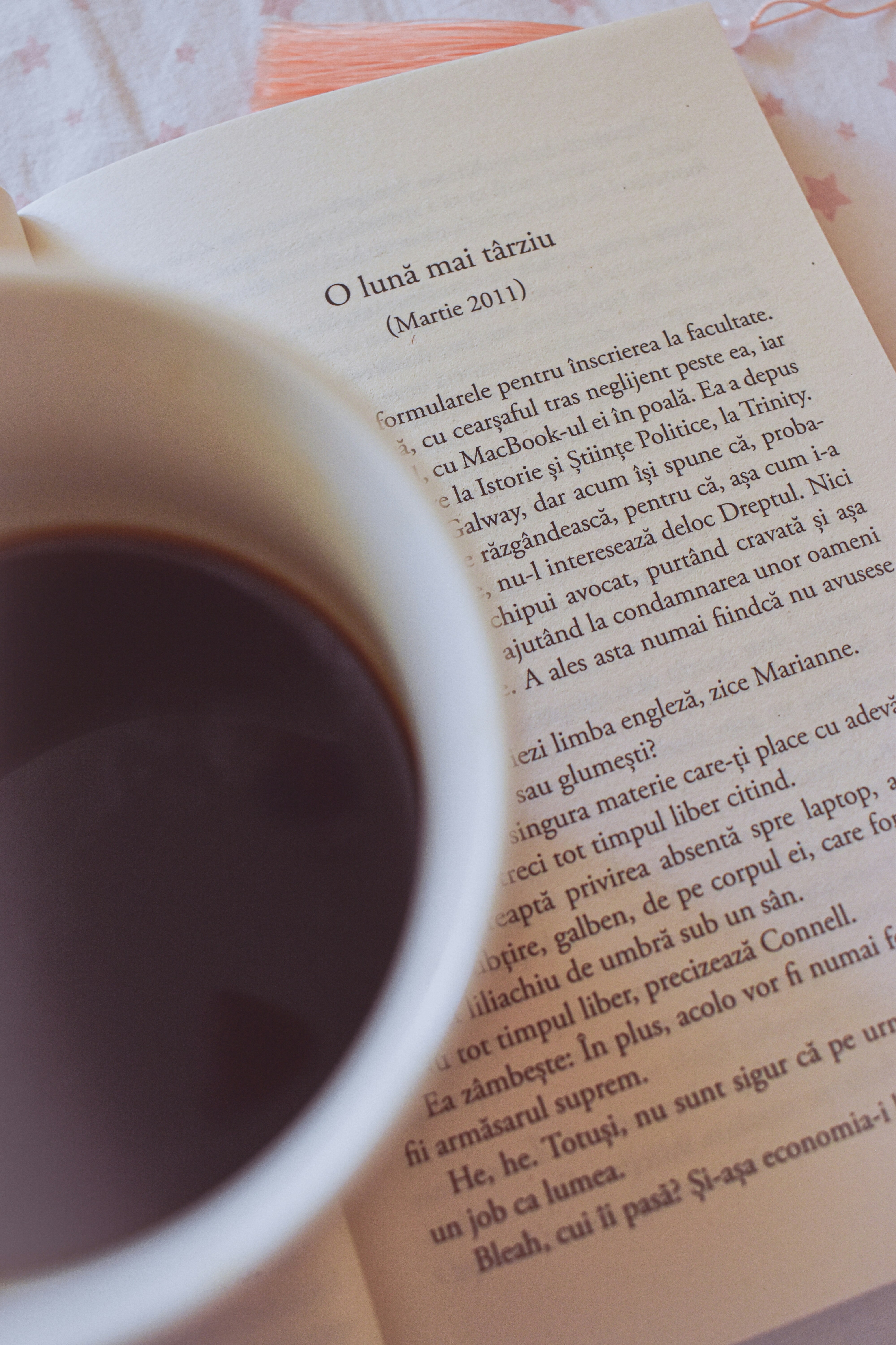 a cup of coffee sitting on top of an open book