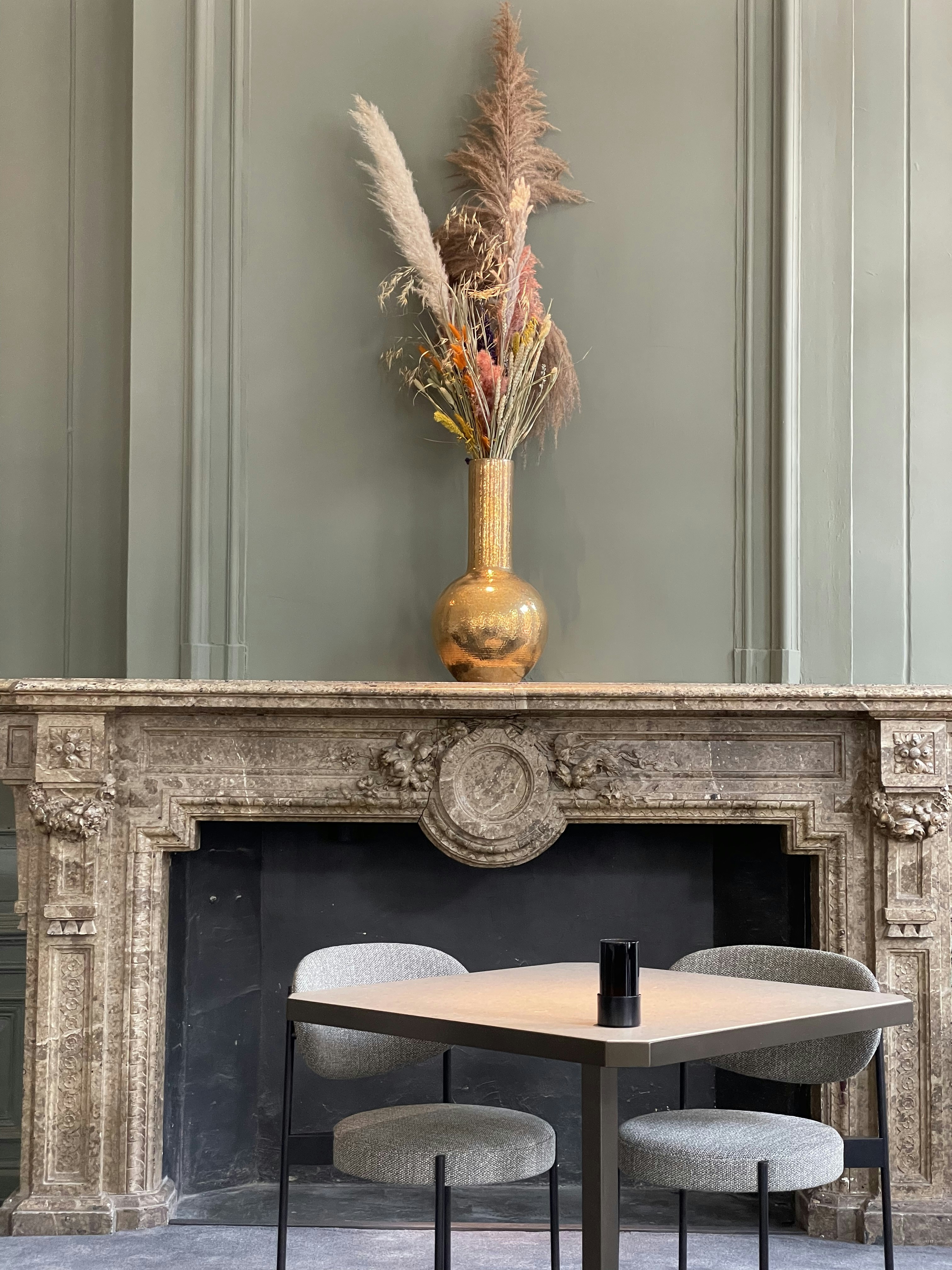 a table and chairs in front of a fireplace