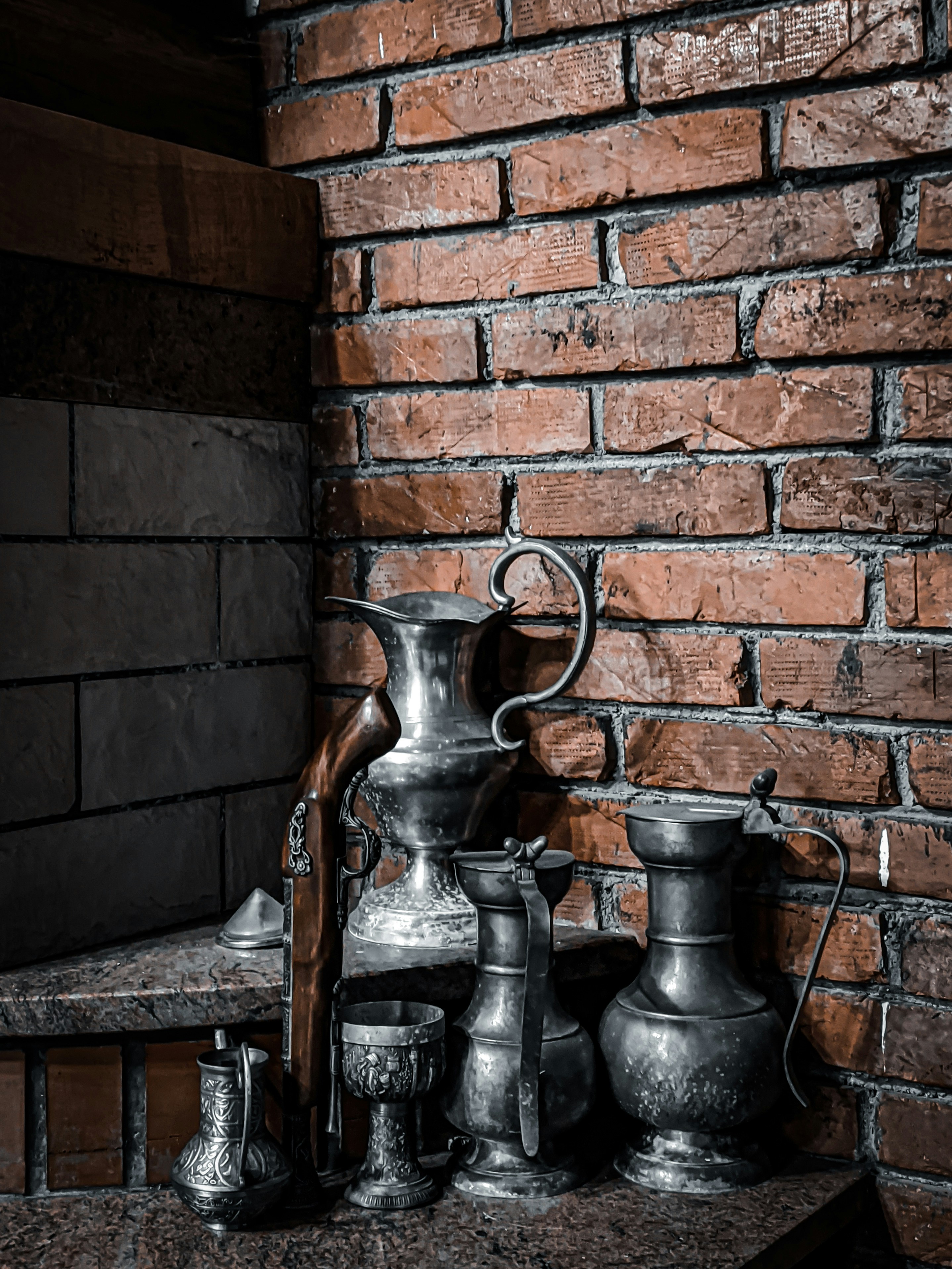 a group of metal pitchers sitting on top of a table