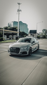 An influencer filming a dynamic video review of a new car model on city streets.