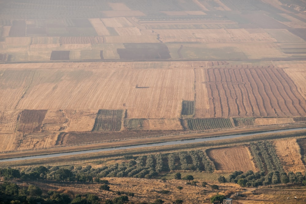 an aerial view of a field with a river running through it