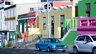 a couple of cars parked next to each other on a street