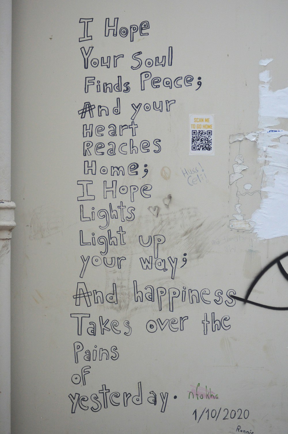 a white wall with graffiti written on it