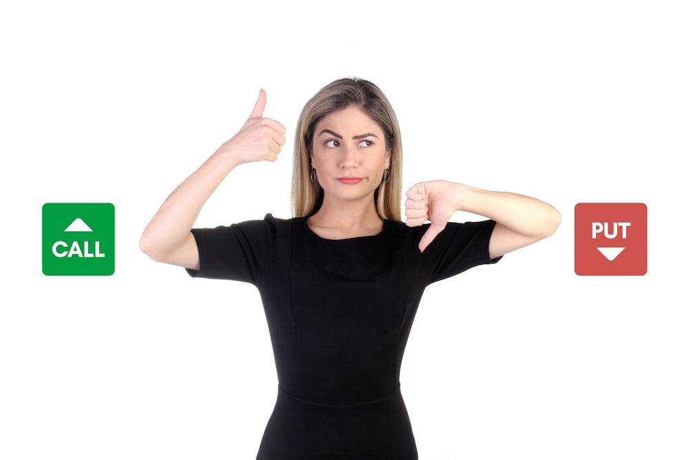 a woman in a black shirt is pointing at buttons