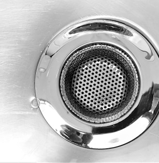a close up of a metal sink drain