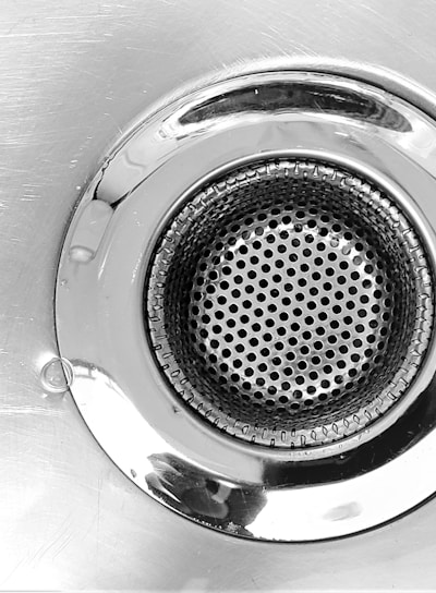 a close up of a metal sink drain