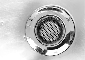 a close up of a metal sink drain