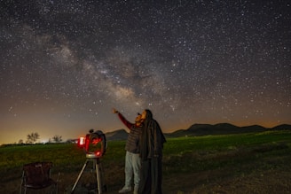 A guest enjoying a guided stargazing session , looking through a high-power telescope.