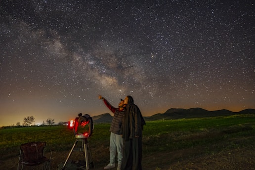 A guest enjoying a guided stargazing session , looking through a high-power telescope.