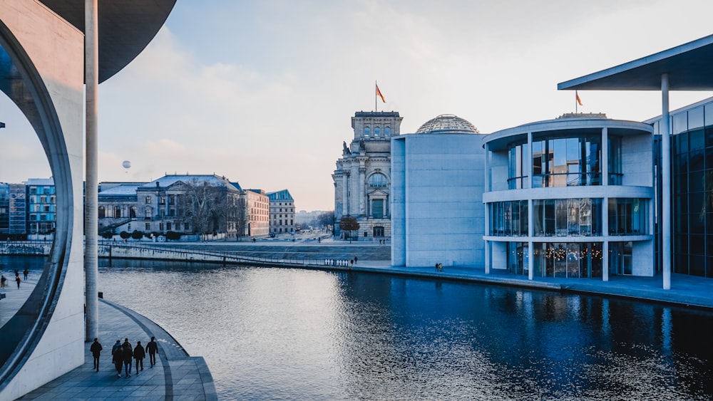 a body of water next to a tall building