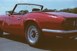 A shiny convertible cruising down an open Texas highway under a bright blue sky.