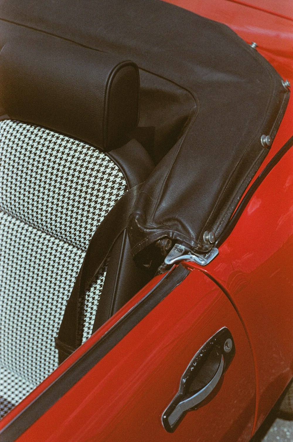 a close up of a red car with a black and white seat