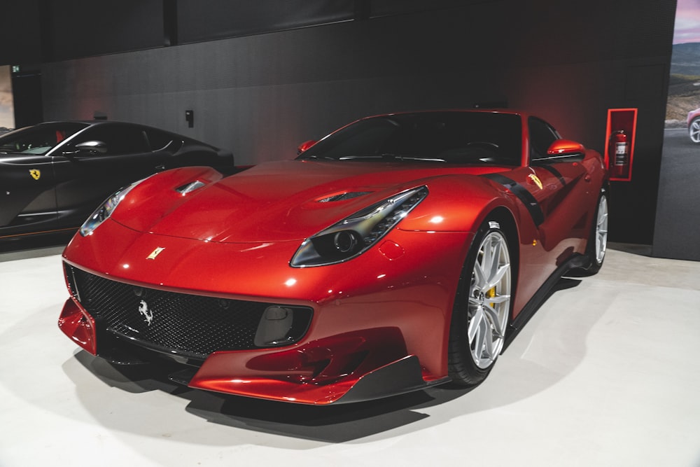 a red sports car parked next to a black sports car