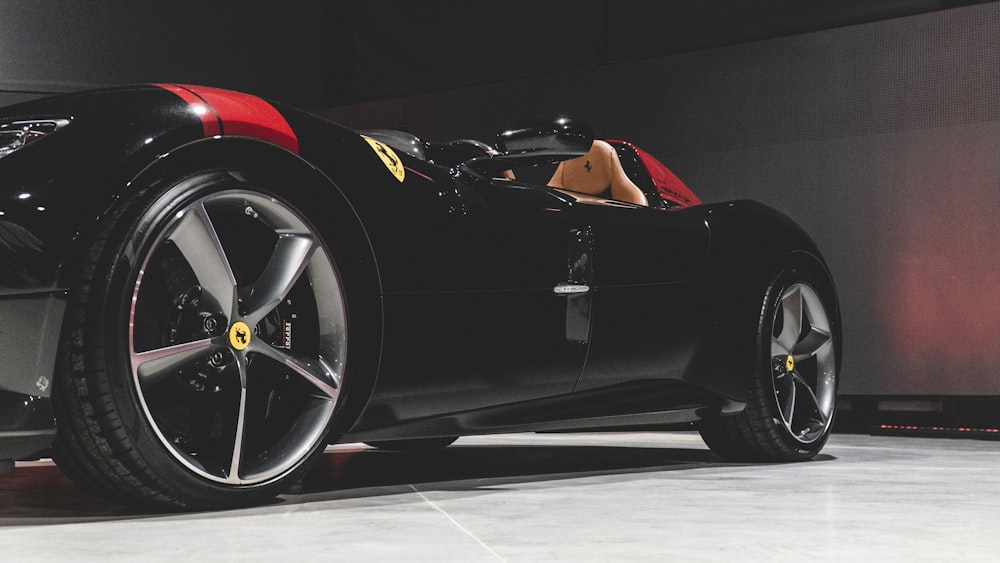 a black sports car with a red interior