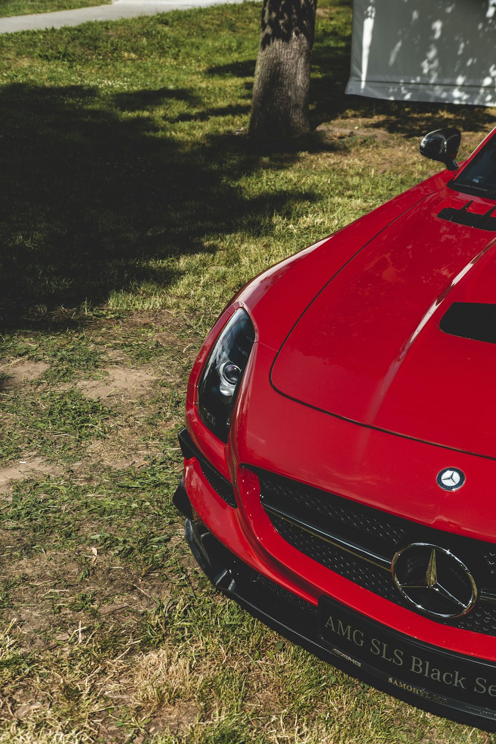 a red sports car parked in the grass