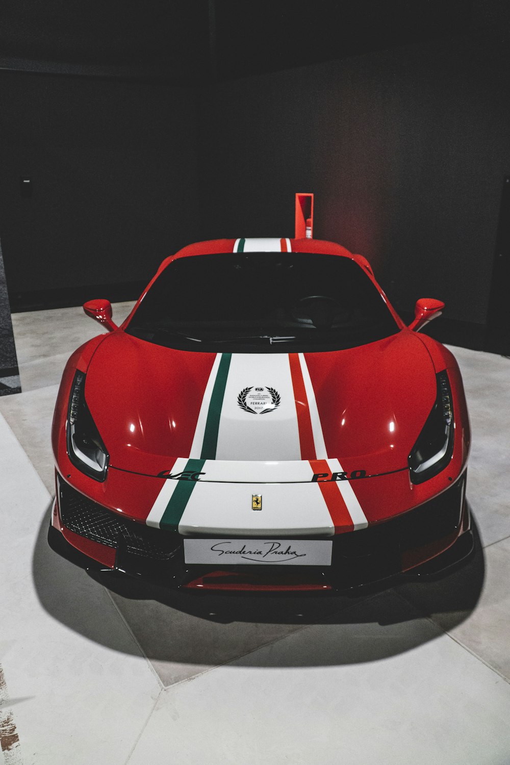 a red sports car with white and green stripes